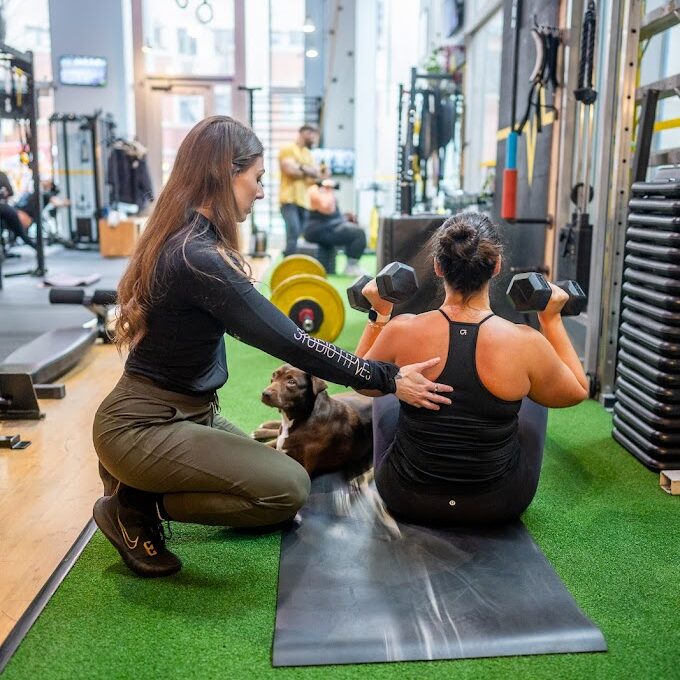 Owner training client and a Dog in the background